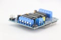 Motor driver or servo shield with a close up view of connection pins on a white background