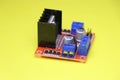 Motor driver used in interface between motor and control circuits used to make electronic projects on yellow background. Driver