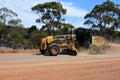 Motor Grader flatting a dirt road surface in Western Australia Royalty Free Stock Photo