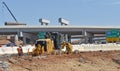 A motor grader prepares a highway off-ramp