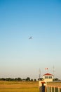 Motor hang glider with passengers flying over aerodrome in clear blue sky Royalty Free Stock Photo