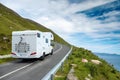 Motor home moving on a small narrow road in a mountains,