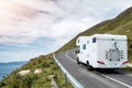 Motor home moving on a small narrow road in a mountains,