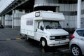 Motor home old 1980's style van parked by the road side in the city.