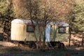 Motor home in park forest mountain in autumn vibrant woodland trees vacation weekend concept