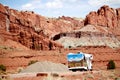 Motor home RV traveling through red rocks in Utah.