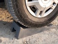 Motor home wheel on camper level up chock block