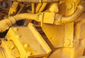 Motor mechanics yellow excavator tractor engine close-up hydraulic machines