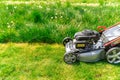 Motor mower to mow the lawn next to the family house Royalty Free Stock Photo