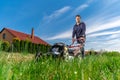 Motor mower to mow the lawn next to the family house Royalty Free Stock Photo