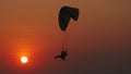 Motor paraglider flying through colorful sunset sky Royalty Free Stock Photo