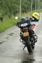 Motor of the police parked on the street with helmet on the motor at scene of an incident.