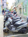 Motor scooters parked at side of street