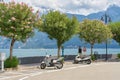 Motor scooters and tourists on the promenade on the shore of Lake Garda in the popular resort of Limone Sul Garda