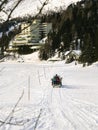 Motor sled moving towards a hotel on a frozen lake at Turracher Hohe Royalty Free Stock Photo