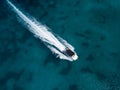 Motor speedboat moving on crystal emerald sea water. Above drone view Royalty Free Stock Photo