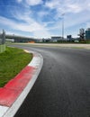 Motor sport circuit asphalt empty track turn and curb surface level view Royalty Free Stock Photo