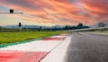 Motor sport circuit asphalt track background curb close up on straight and green field