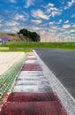 Motor sport circuit asphalt track background curb close up on straight and green field