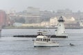 Motor yacht Annabel passing Palmer Island Light Station on foggy morning Royalty Free Stock Photo