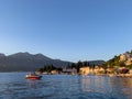 Motor yacht in the sea near the ancient resort town at the foot of the mountains