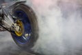 Motorbike burning tire rubber on road, Motorbike wheel drifting and white smoking on track, Motorcycle wheel on racing track with