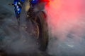 Motorbike burning tire rubber on road, Motorbike wheel drifting and white smoking on track, Motorcycle wheel on racing track with