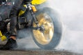 Motorbike burning tire rubber on road, Motorbike wheel drifting and white smoking on track, Motorcycle wheel on racing track with