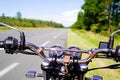 Motorbike chrome handlebars of classic vintage motorcycle parked in a road in summer countryside Royalty Free Stock Photo