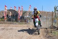 A motorbike cross racer is practicing on a dusty track