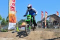 A motorbike cross racer is practicing on a dusty track