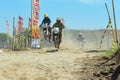 A motorbike cross racer is practicing on a dusty track