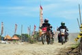 A motorbike cross racer is practicing on a dusty track