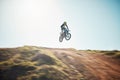 Motorbike, cycling and jump on blue sky mockup for speed challenge, sports and fearless athlete. Driver, air stunt and Royalty Free Stock Photo