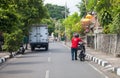 a motorbike driver pushes his motorbike on a road