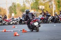 Motorbike driver riding bike on urban square using it as motordrome, rear view Royalty Free Stock Photo