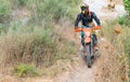 Motorbike driver is riding in plants field