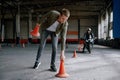 Motorbike driving school lesson with instructor putting cone on track Royalty Free Stock Photo