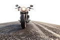Motorbike on an Empty Desert Road Isolated on White Background, Depth of Field Royalty Free Stock Photo