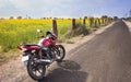 Motorbike in between fields and roads Royalty Free Stock Photo