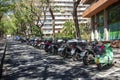 Motorbike group parking on urban greening and quiet street Royalty Free Stock Photo