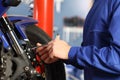 Motorbike mechanic hands disassembling parts