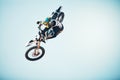 Motorbike, outdoor jump and man on blue sky mockup for speed challenge, sports risk and fearless skill. Driver, air Royalty Free Stock Photo