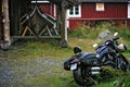 Motorbike outside a hut with a boat