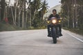 Motorbike on the palm trees road riding. driving the empty road on a motorcycle tour journey. Royalty Free Stock Photo