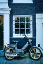 Motorbike parked near old house in Amsterdam street,