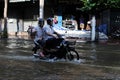 Motorbike Rider Navigates a Flooded Street