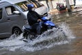 Motorbike Rider Navigates a Flooded Street