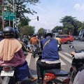 motorbike riders are waiting fortraffic lights around Jakarta