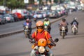 Motorbike taxis on a wide avenue in the capital city, Kampala, Uganda. Royalty Free Stock Photo